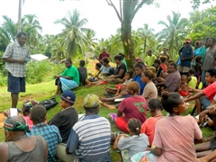 Talking to villagers during public awareness campaign